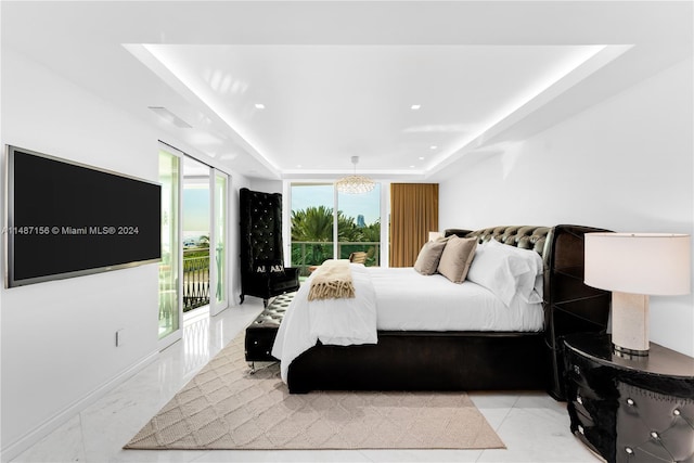 tiled bedroom featuring a raised ceiling, access to exterior, and multiple windows