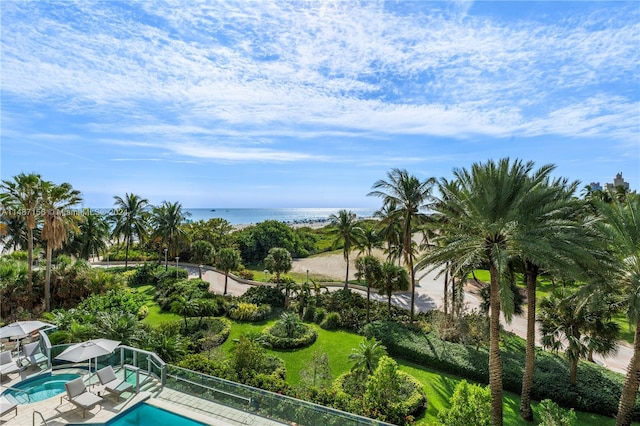 view of pool with a water view and a patio area