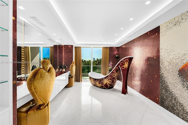 tiled bedroom featuring a wall of windows and a raised ceiling