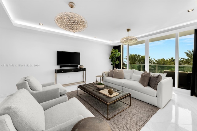 living room with a raised ceiling and light tile flooring