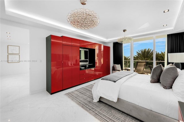 bedroom featuring a wall of windows, access to exterior, a raised ceiling, and light tile floors