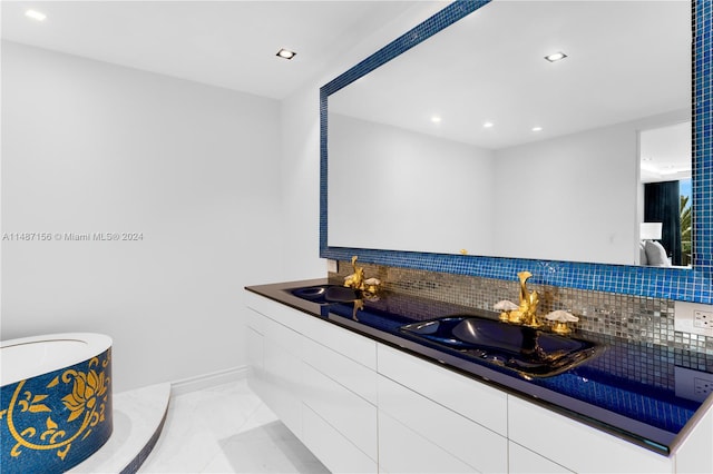 bathroom with double sink vanity, tile floors, and tasteful backsplash