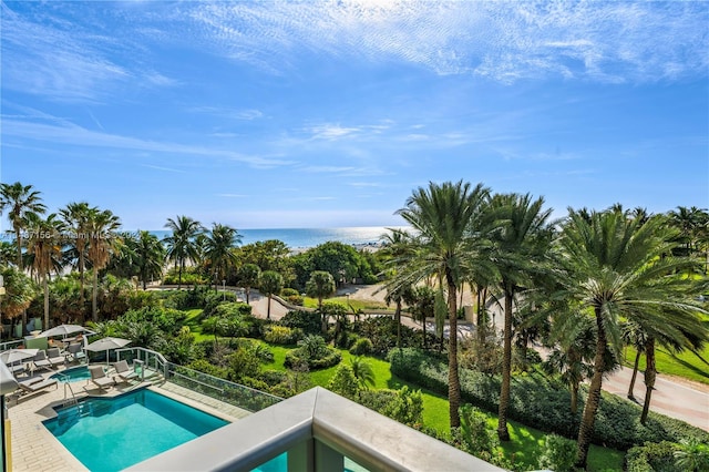 view of swimming pool featuring a water view and a patio area