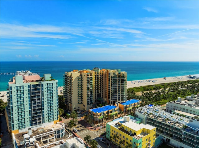 drone / aerial view featuring a water view and a view of the beach