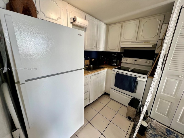 kitchen with white cabinets, white appliances, sink, and light tile floors