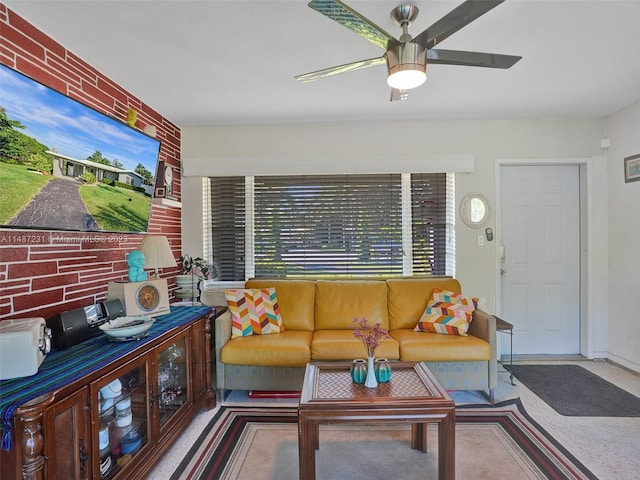 living room with brick wall and ceiling fan