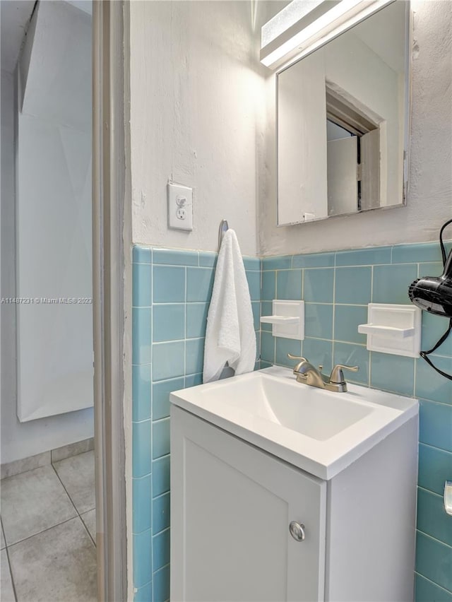 bathroom featuring tile flooring, oversized vanity, tasteful backsplash, and tile walls