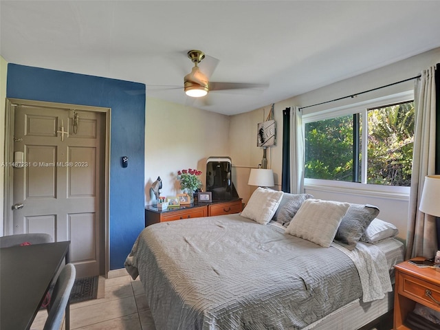 tiled bedroom with ceiling fan