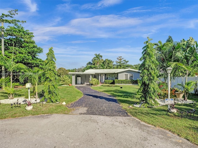 ranch-style home featuring a front yard