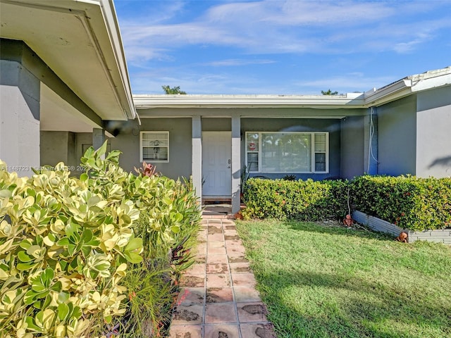 doorway to property featuring a yard