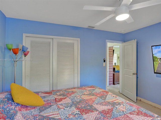 carpeted bedroom featuring a closet and ceiling fan