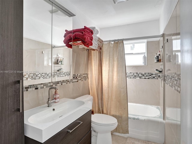 full bathroom featuring tile walls, toilet, shower / tub combo, tile flooring, and vanity