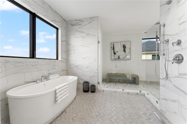10455 SW 57th Ct, Cooper City, FL 33328 - bathroom featuring a healthy amount of sunlight, tile flooring, and tile walls