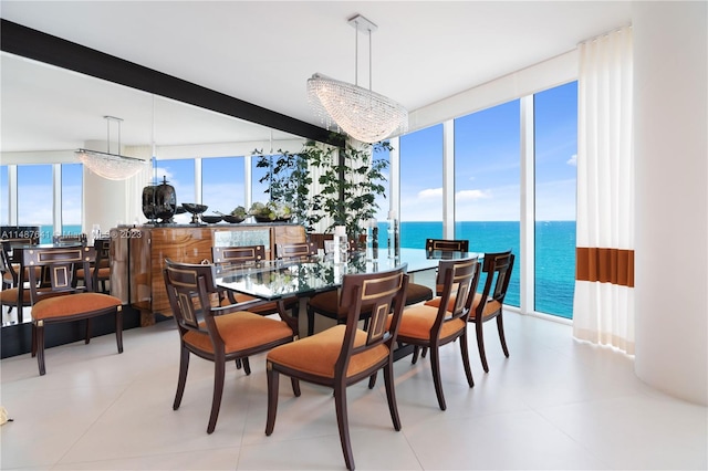 tiled dining space featuring a notable chandelier, a wall of windows, and a water view