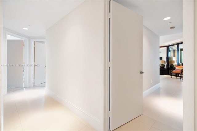 hall featuring light tile flooring