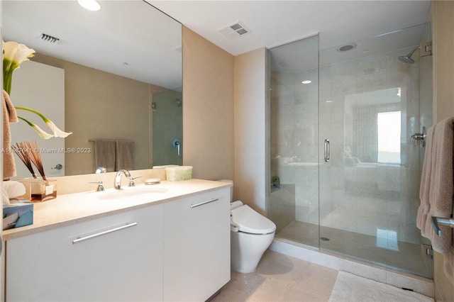 bathroom with vanity, tile floors, toilet, and walk in shower