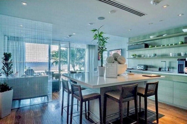 kitchen featuring a kitchen island, light hardwood / wood-style floors, and a kitchen bar