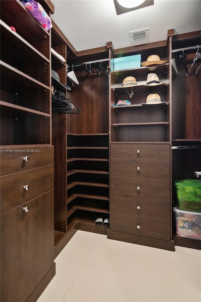 spacious closet with light tile floors