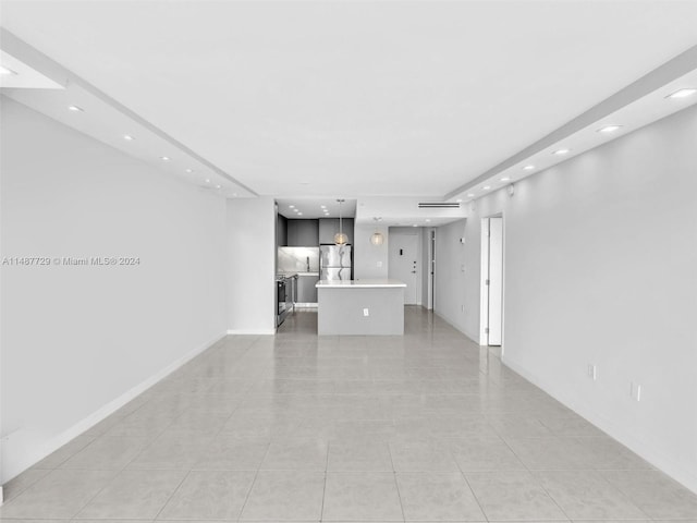 unfurnished living room featuring light tile floors