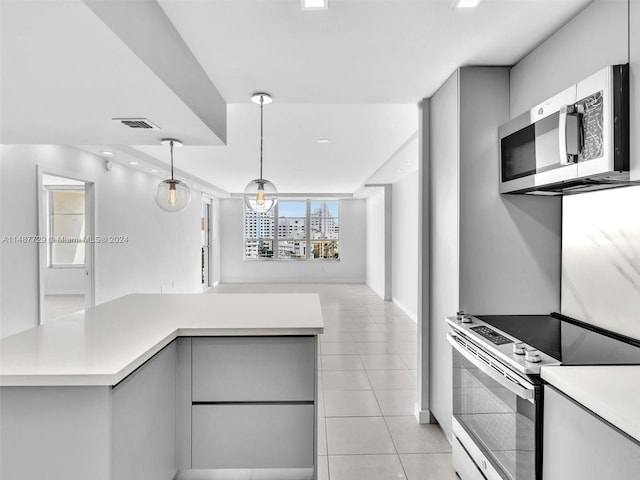 kitchen with decorative light fixtures, light tile floors, stainless steel appliances, and gray cabinets