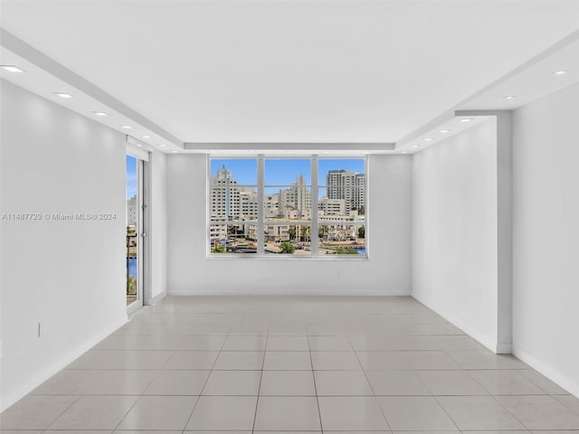 empty room featuring light tile flooring and a wealth of natural light