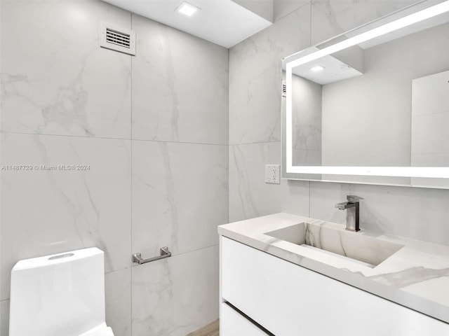 bathroom featuring tile walls and vanity