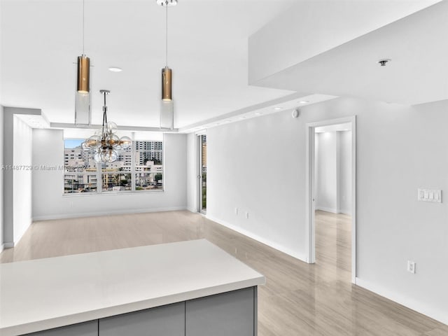 kitchen featuring hanging light fixtures and a notable chandelier