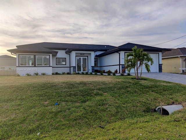 view of front facade with a lawn and a garage