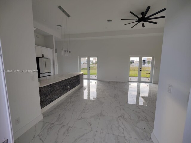 kitchen with light tile floors, white cabinets, french doors, and a wealth of natural light