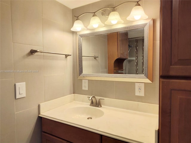 bathroom with vanity and tile walls