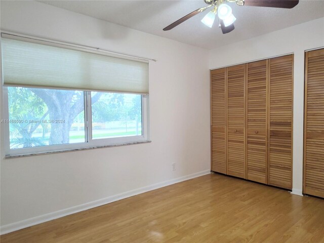 7083 W Sunrise Blvd Unit 7083, Plantation, FL 33313 - unfurnished bedroom featuring light wood-style floors, baseboards, multiple closets, and a ceiling fan