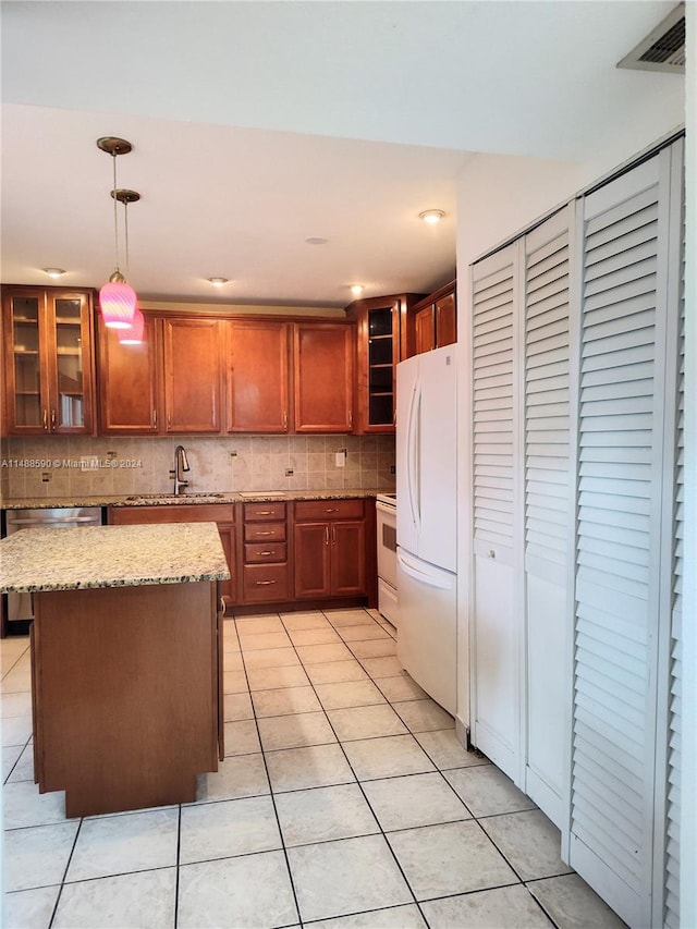 kitchen featuring sink, pendant lighting, white appliances, decorative backsplash, and light tile patterned floors