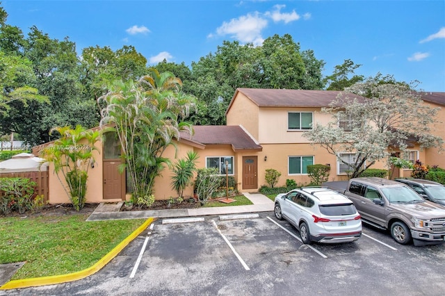 7083 W Sunrise Blvd Unit 7083, Plantation, FL 33313 - view of property featuring stucco siding and uncovered parking