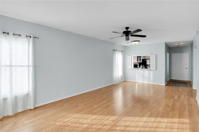 unfurnished living room featuring ceiling fan and light hardwood / wood-style flooring