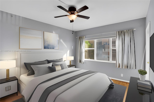 bedroom with wood-type flooring and ceiling fan