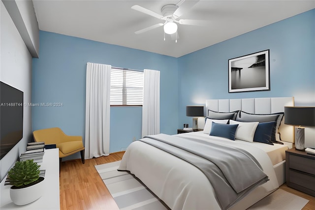 bedroom featuring ceiling fan and light hardwood / wood-style flooring