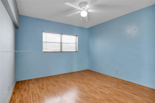 empty room with light hardwood / wood-style flooring and ceiling fan