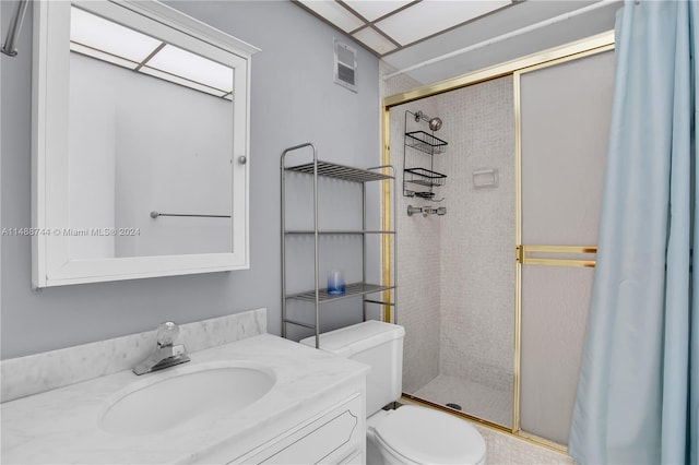 bathroom with a shower with door, toilet, and oversized vanity