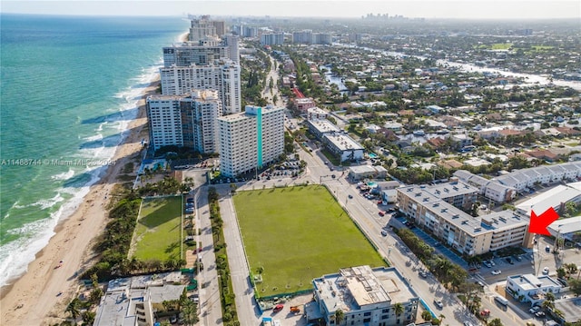 bird's eye view featuring a water view and a view of the beach