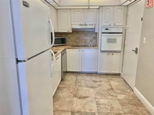 kitchen with backsplash, white appliances, white cabinets, and light tile floors