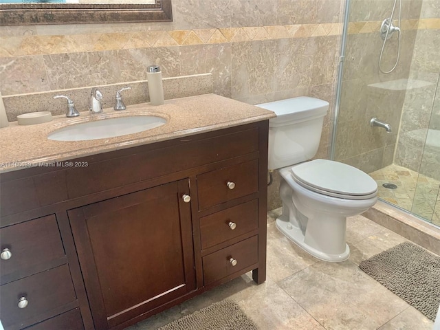 bathroom with vanity, tasteful backsplash, toilet, and tile walls