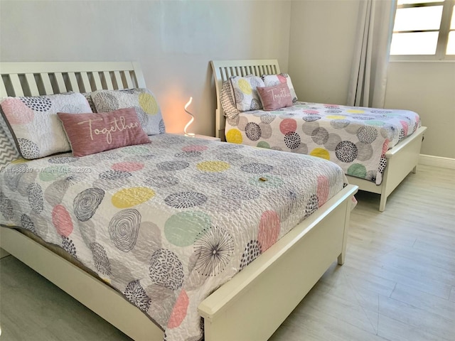 bedroom with light wood-type flooring