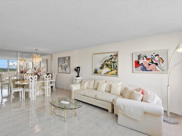 living room featuring a textured ceiling, a notable chandelier, and light tile floors