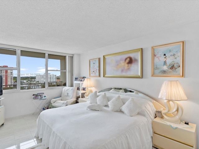 tiled bedroom featuring a textured ceiling