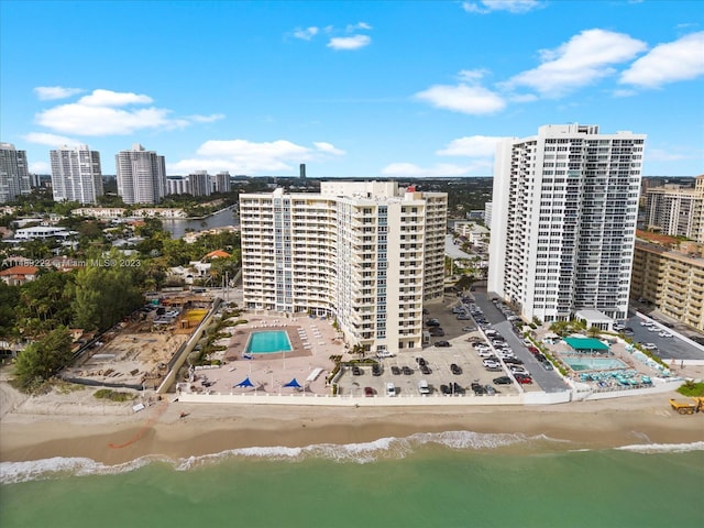 drone / aerial view with a water view and a beach view