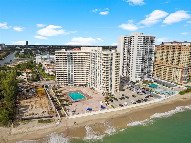 birds eye view of property with a beach view and a water view