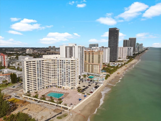 birds eye view of property featuring a water view and a view of the beach