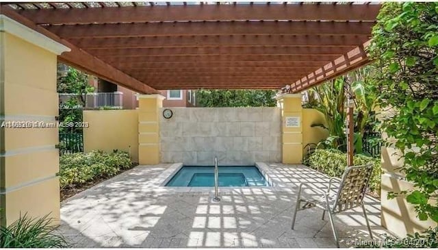 view of patio / terrace with a pergola and a hot tub