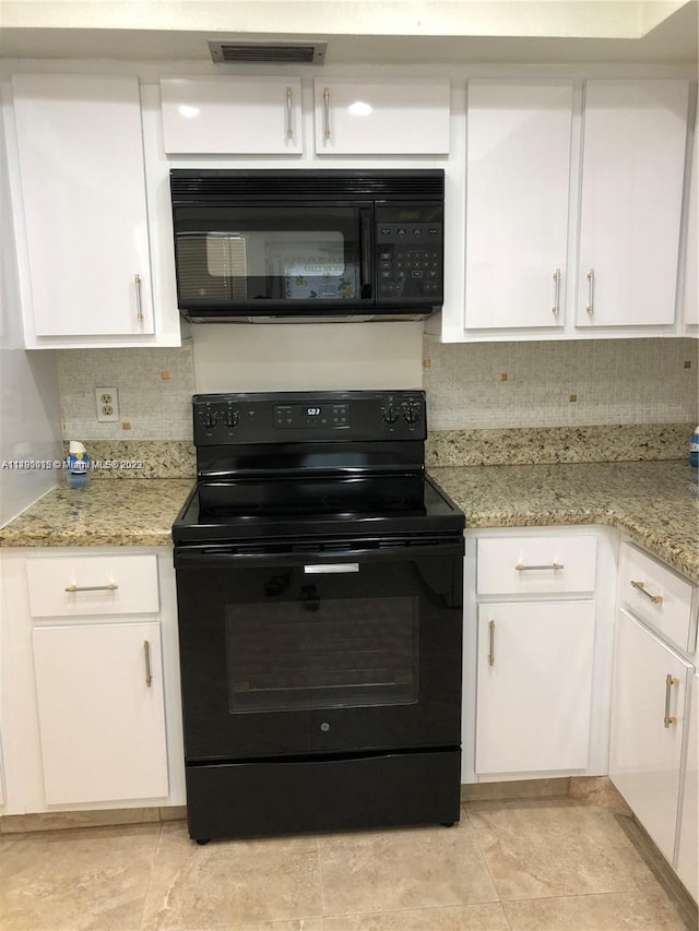 kitchen featuring white cabinetry, black appliances, light tile flooring, light stone counters, and tasteful backsplash