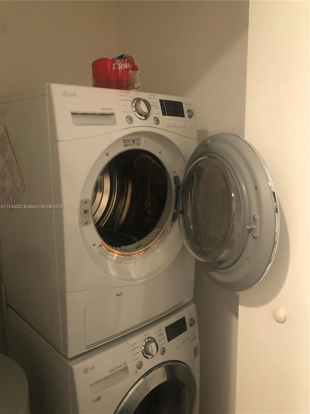 laundry area featuring stacked washing maching and dryer